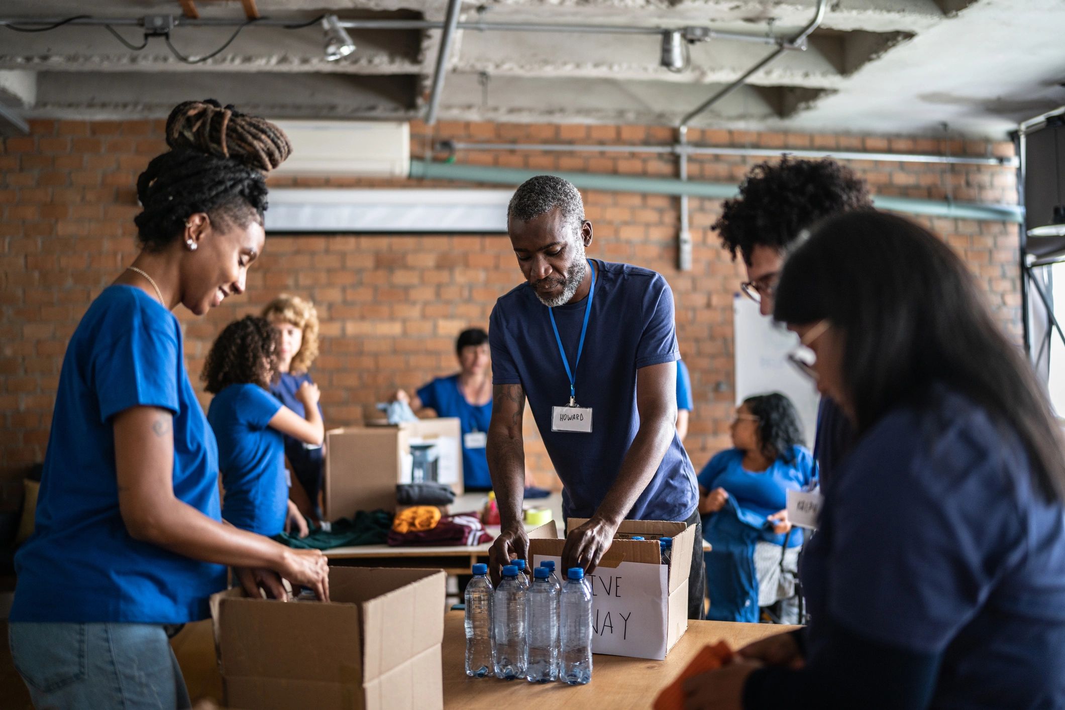 Volunteers arranging donations in a community charity center