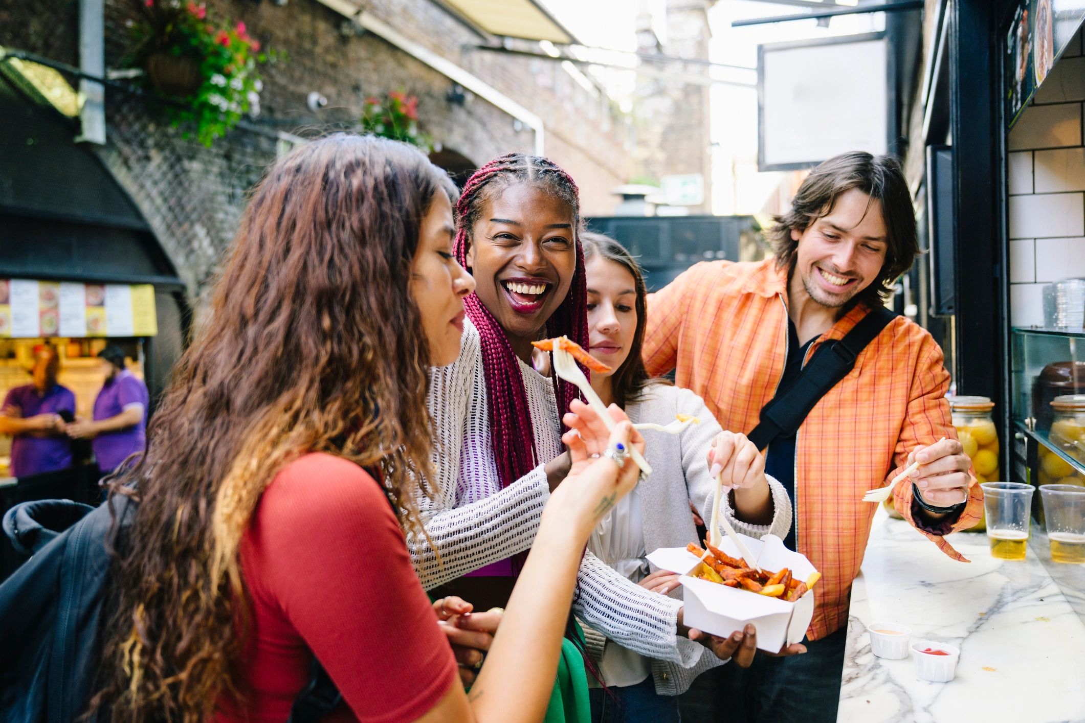 People sharing food and conversation in London