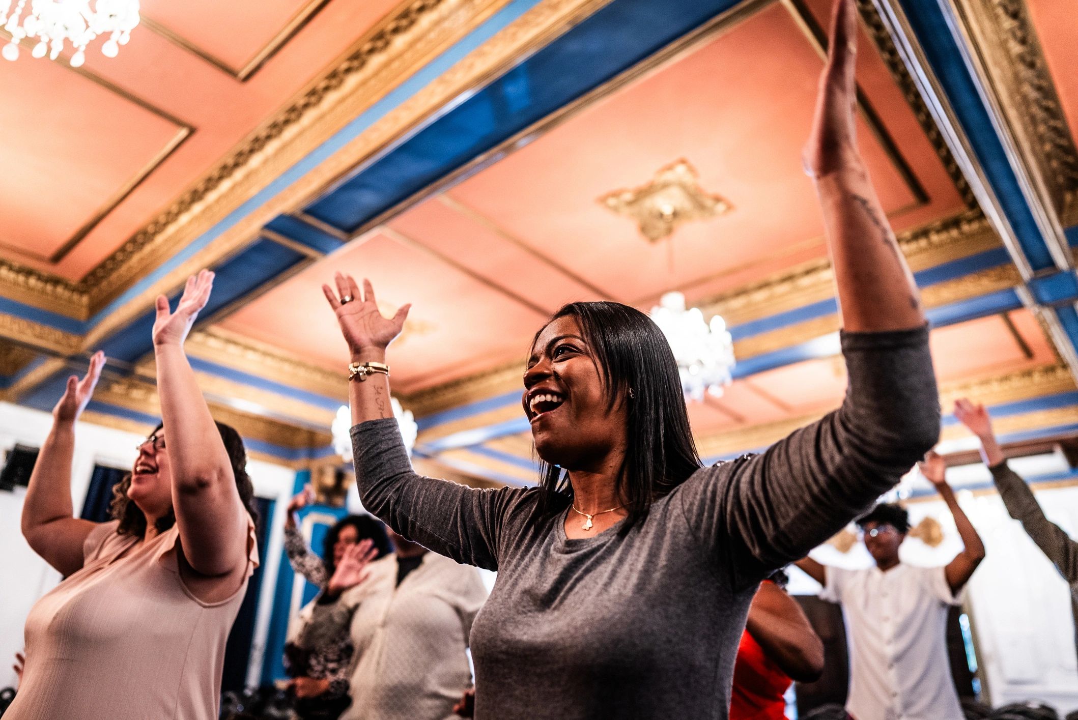 Mature woman raising hands in worship celebration