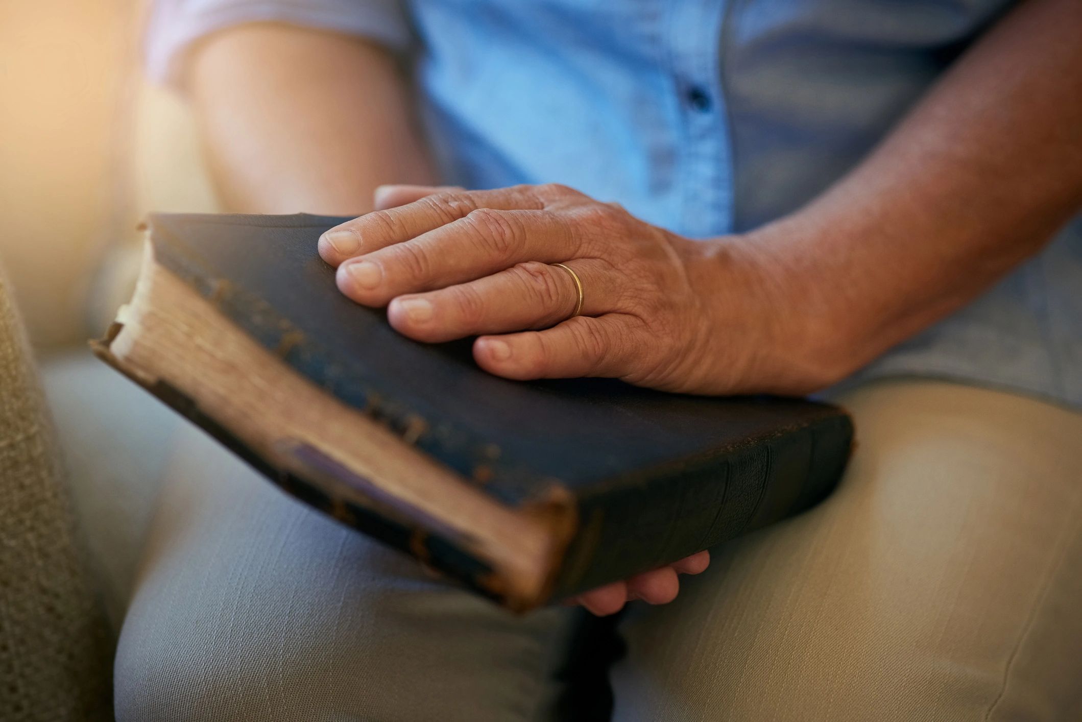 Person holding a Bible during a moment of reflection